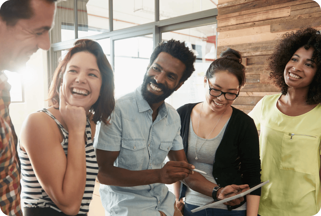 MongoDB emplyoees smiling while looking at a tablet