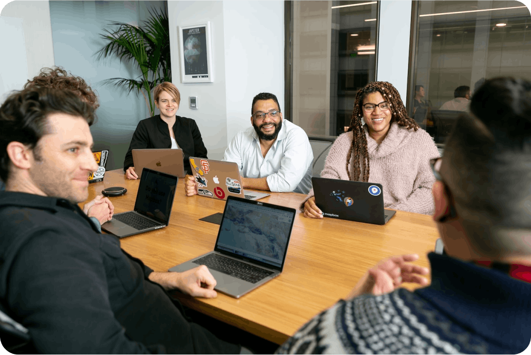 MongoDB employees sitting at a conference table having a discussion